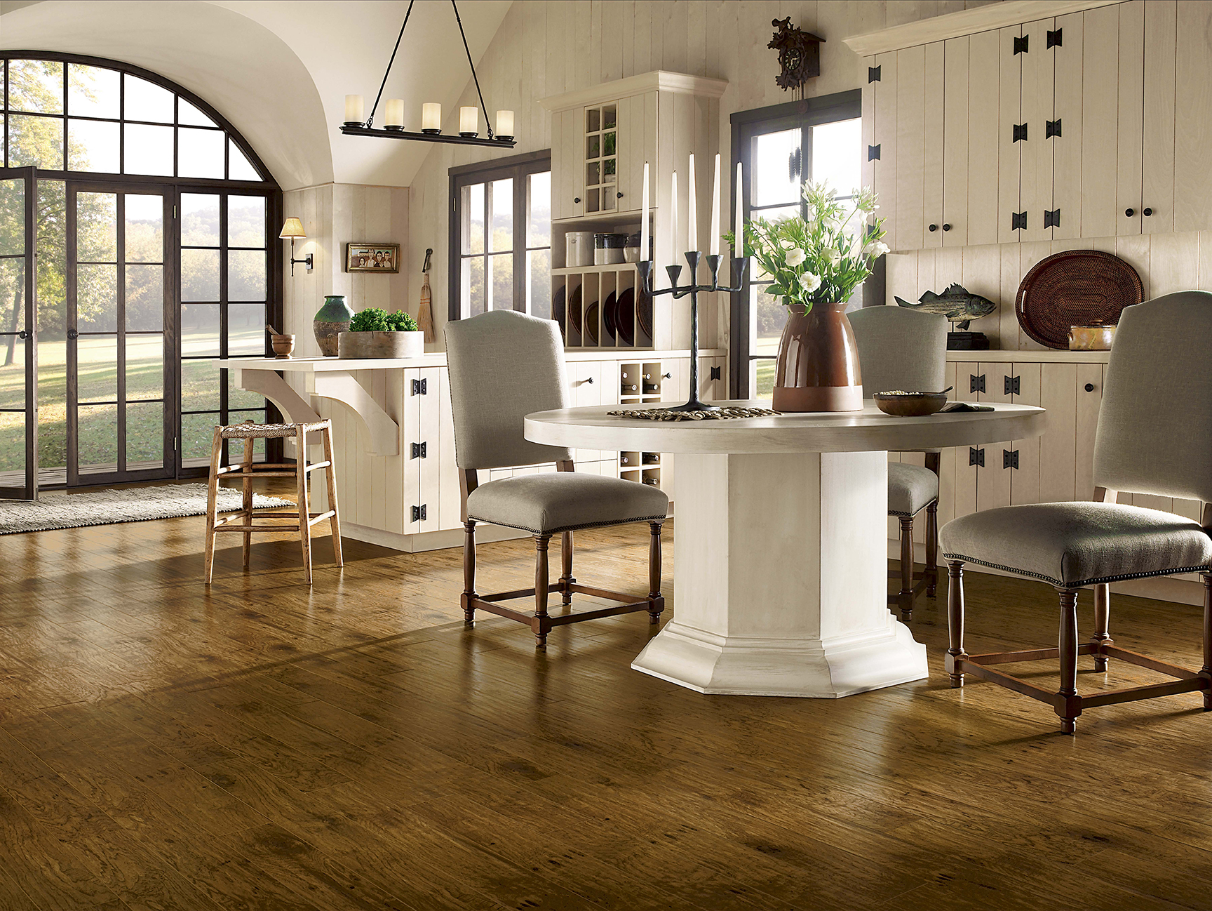 Wide-plank hardwood flooring in a warm, sunlit room