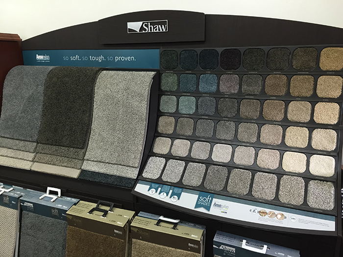 Wall of carpet sample books in the Scharber Flooring showroom